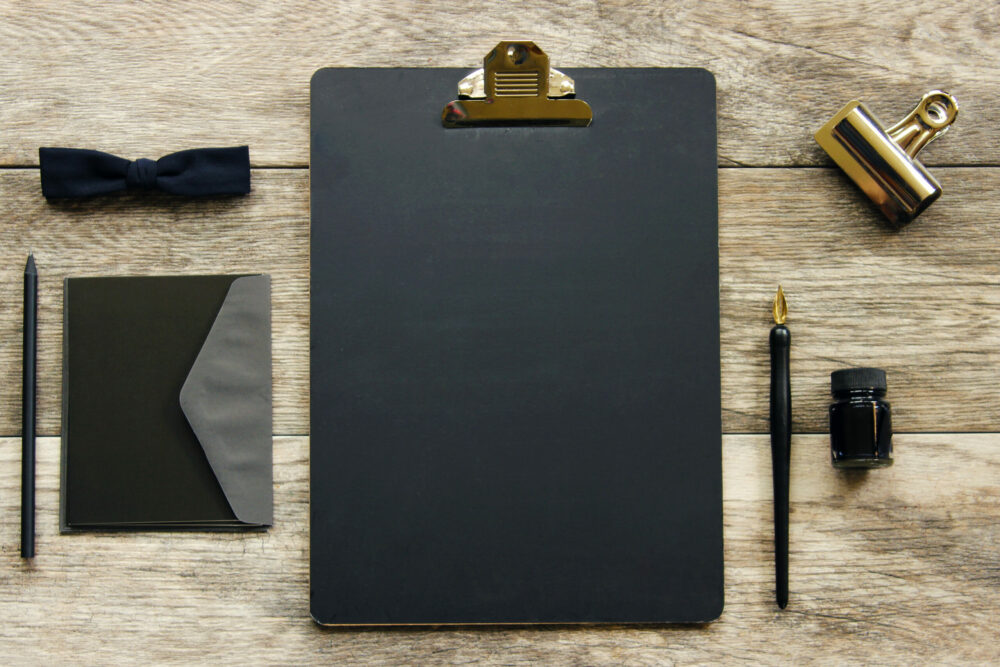 Black Clip Board on a Home Office Desk. The Enlightened Creative.